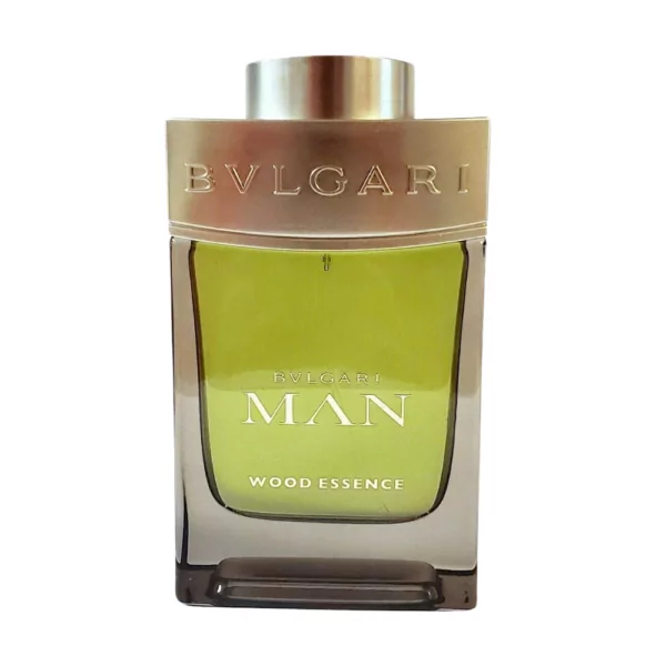 Bvlgari Man Wood Essence EDP 100ml bottle displayed with a natural wooden background, highlighting cedar and vetiver notes.