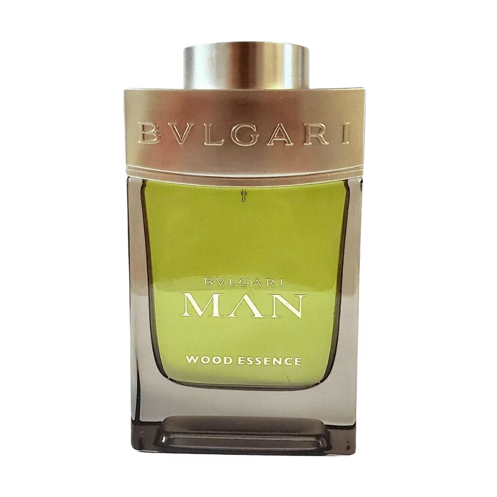 Bvlgari Man Wood Essence Edp 100Ml Bottle Displayed With A Natural Wooden Background, Highlighting Cedar And Vetiver Notes.